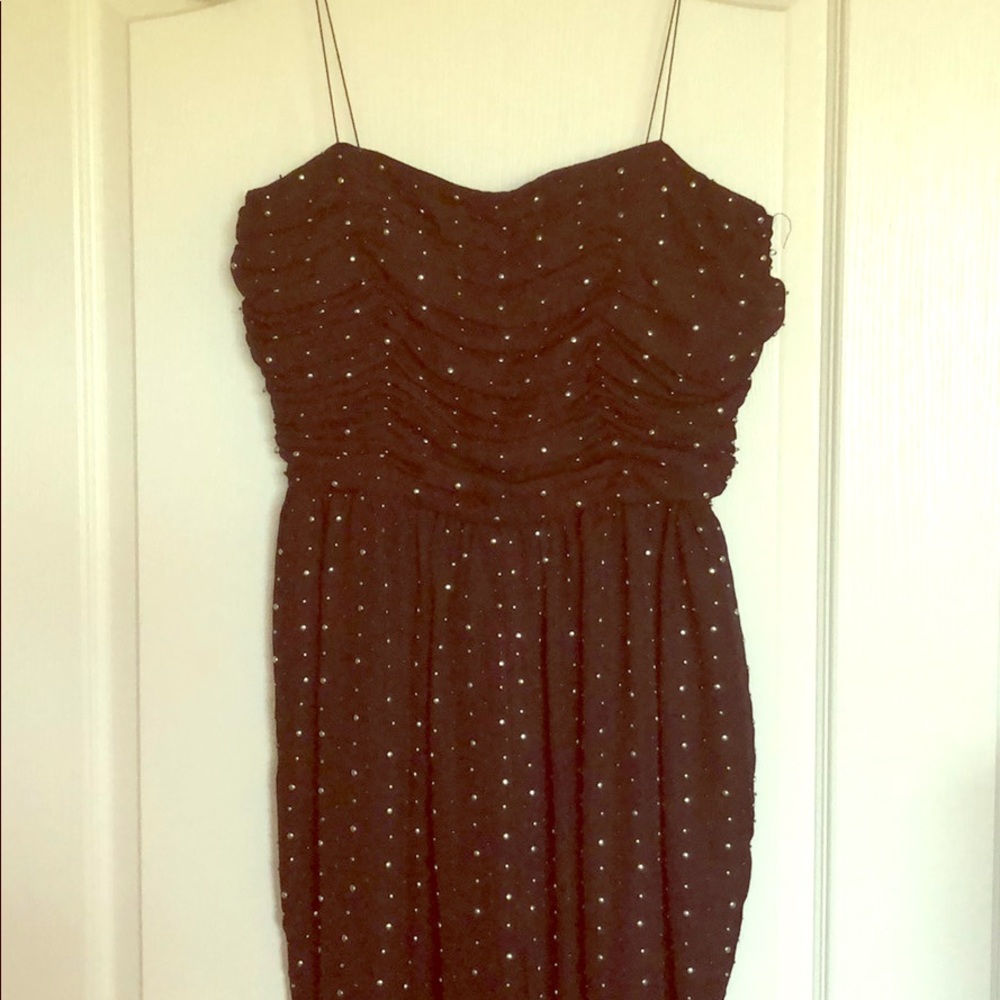 Strapless jumpsuit with pearl adornments.